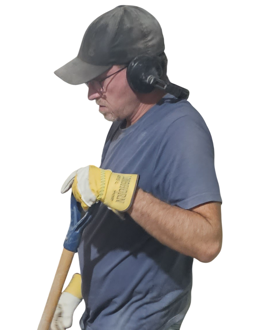 A person wearing a dark cap and gloves holds a tool, set against a solid black background.